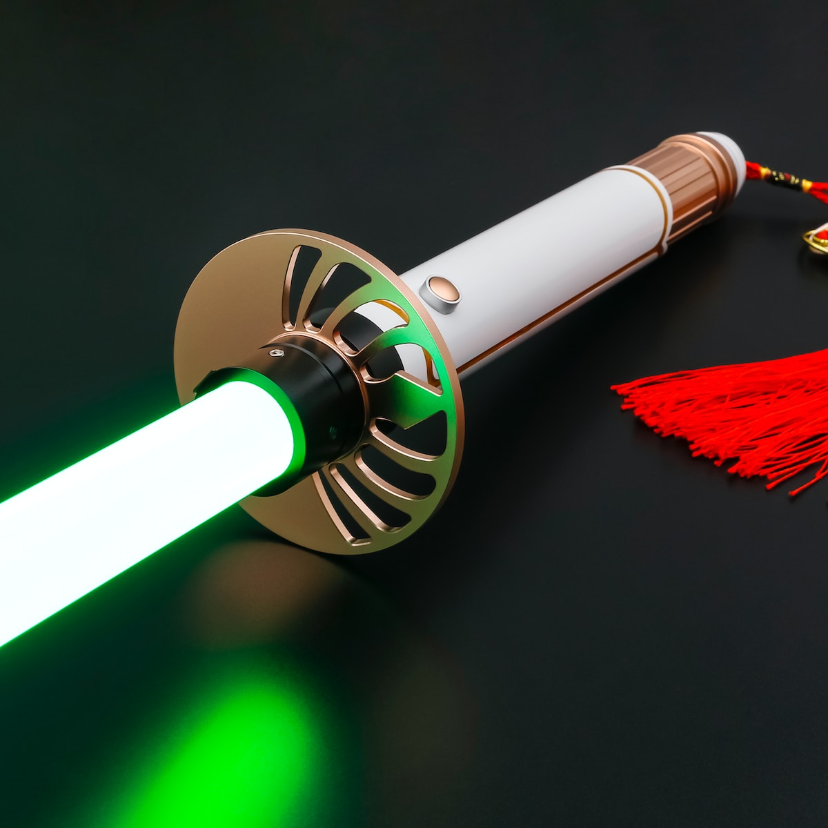 a green and white light saber next to a red tassel