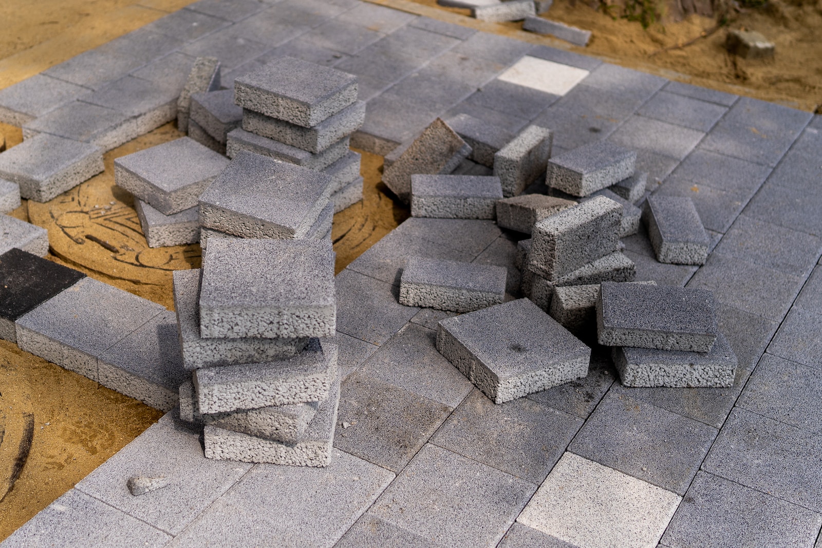 a pile of cement blocks sitting on top of a sidewalk
