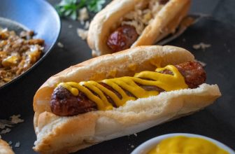 a hot dog with mustard on a bun